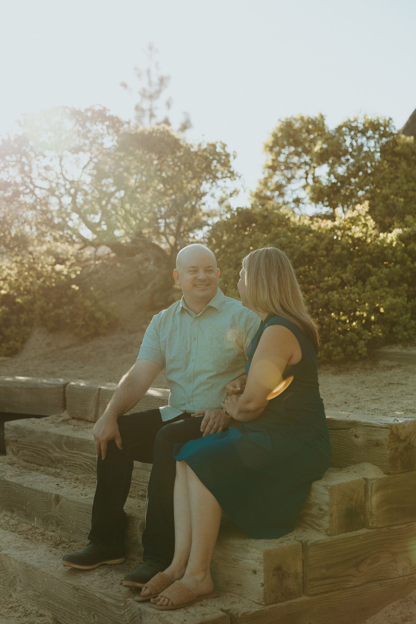 Sitting together on wooden steps in golden-hour sunlight