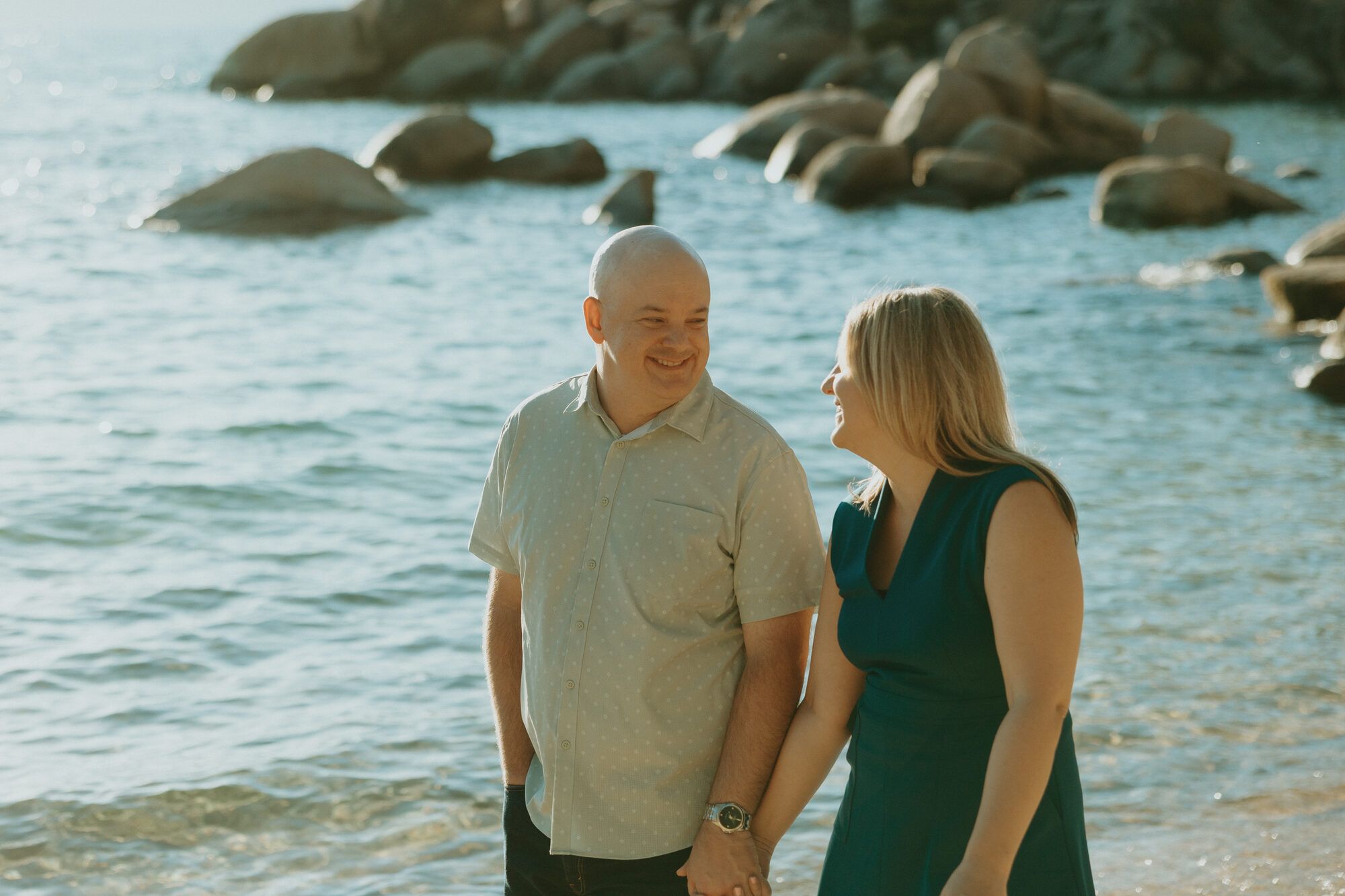 Nicole and Eric laughing together at the water's edge