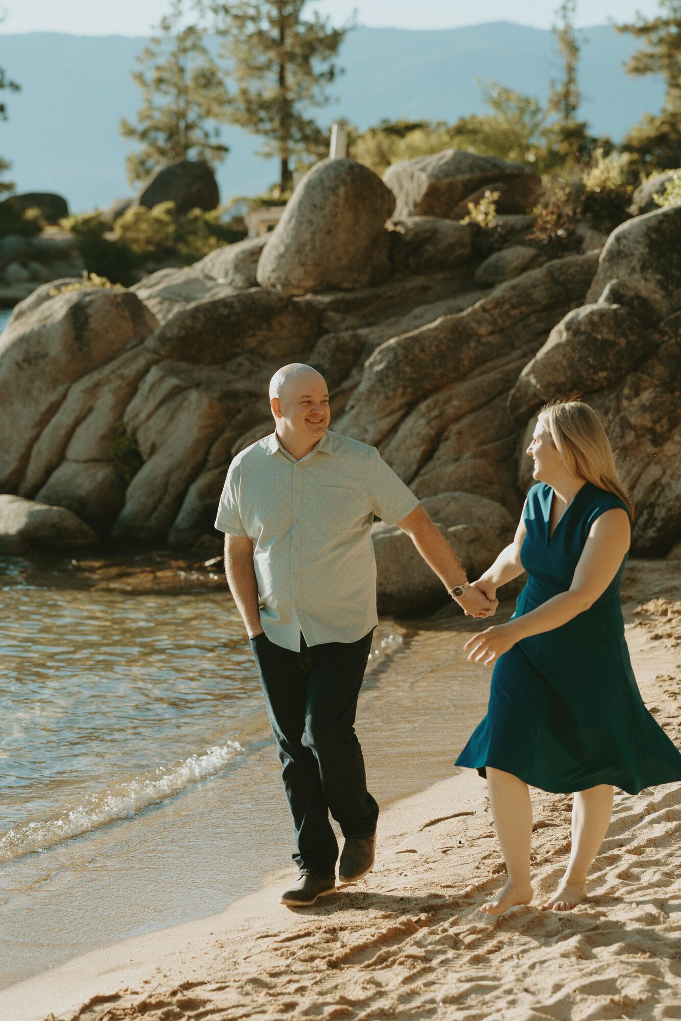 A playful walk on the sand, both beaming