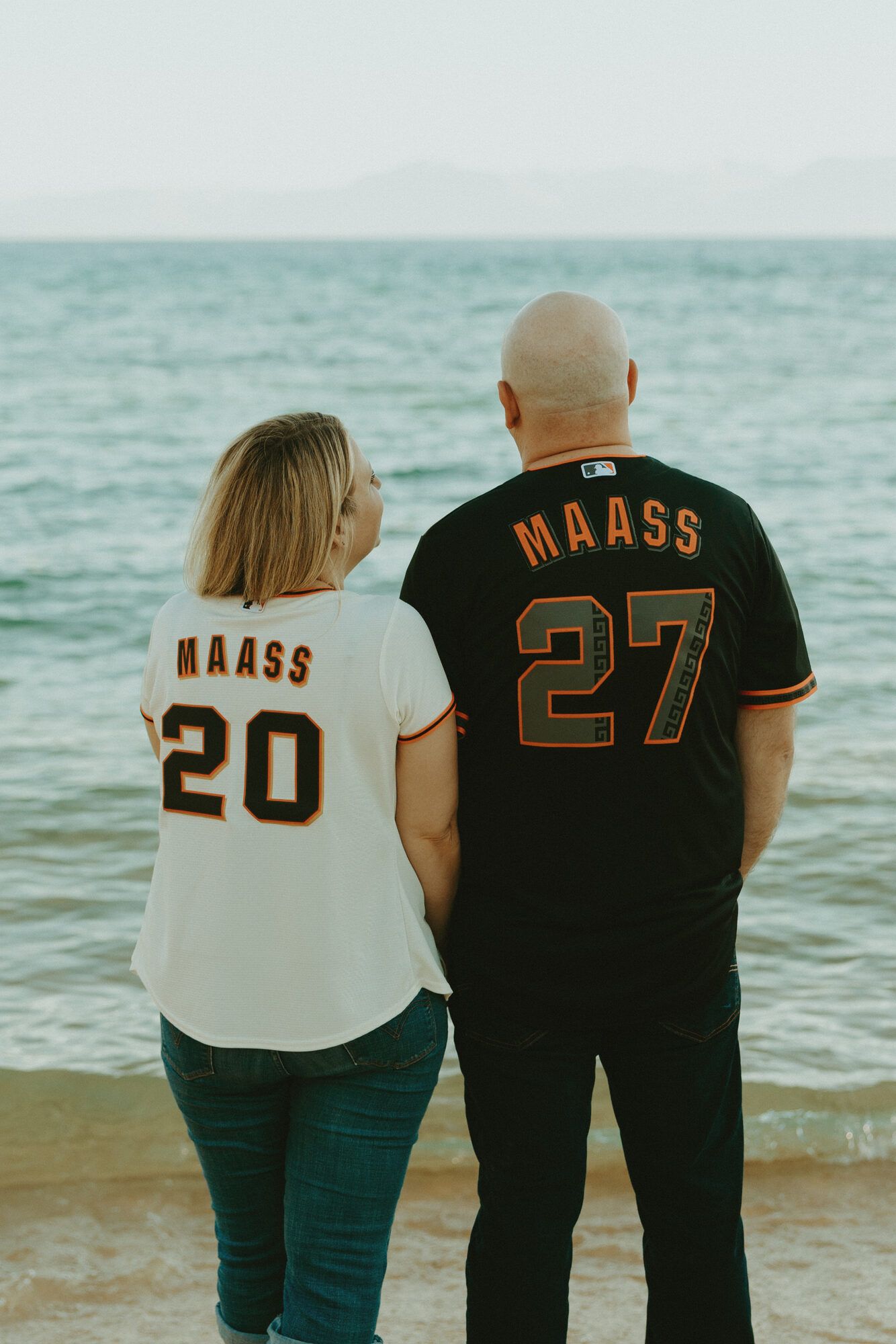 In matching Giants jerseys, facing the lake together